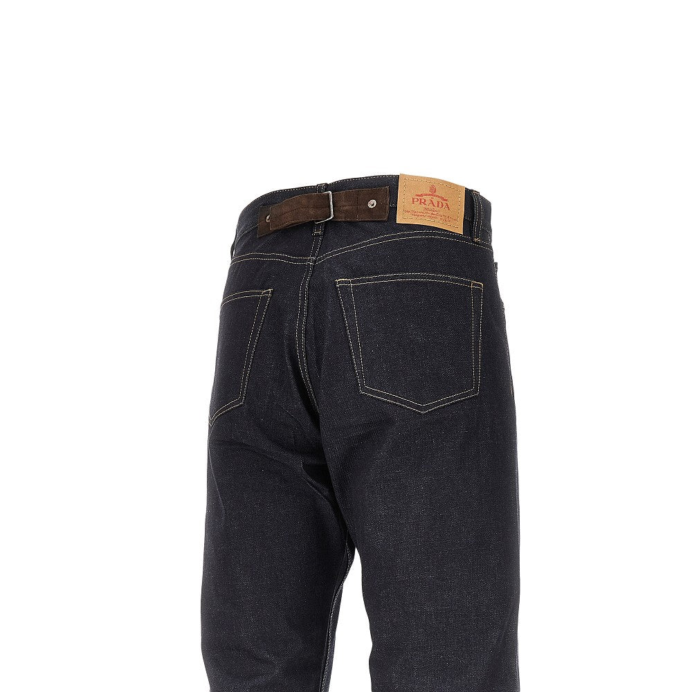 Raw demim jeans with leather buckled strap
