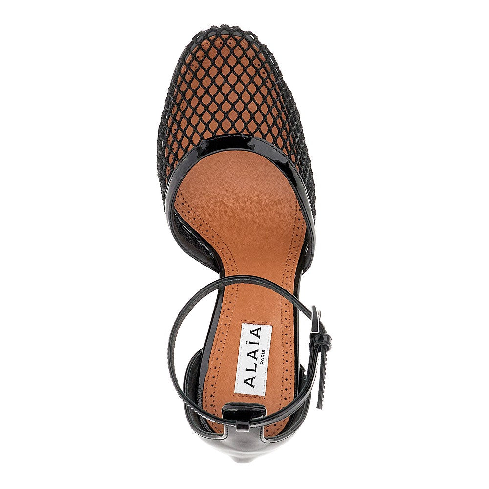 Fishnet and patent leather pumps