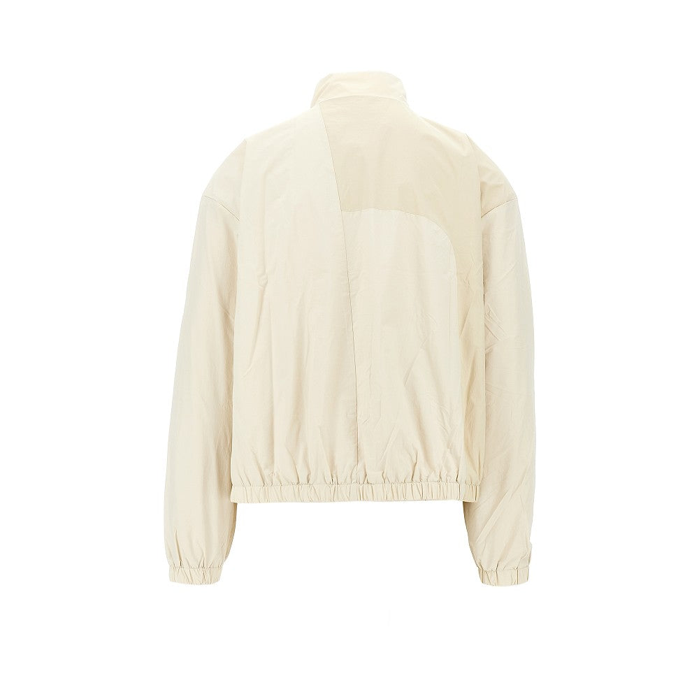 Nylon blouson jacket with curved zip